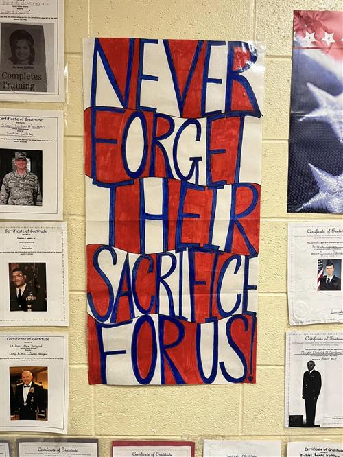 Sign in school saying Never Forget Their Sacrifice For Us